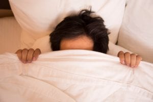 Woman has a deep sleep on white bed